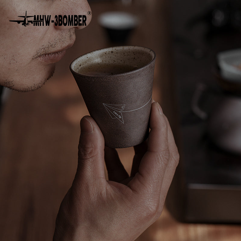 MHW-3BOMBER Winter Cup C5091G Starry Grey held while sipping; close view of the speckled ceramic finish
