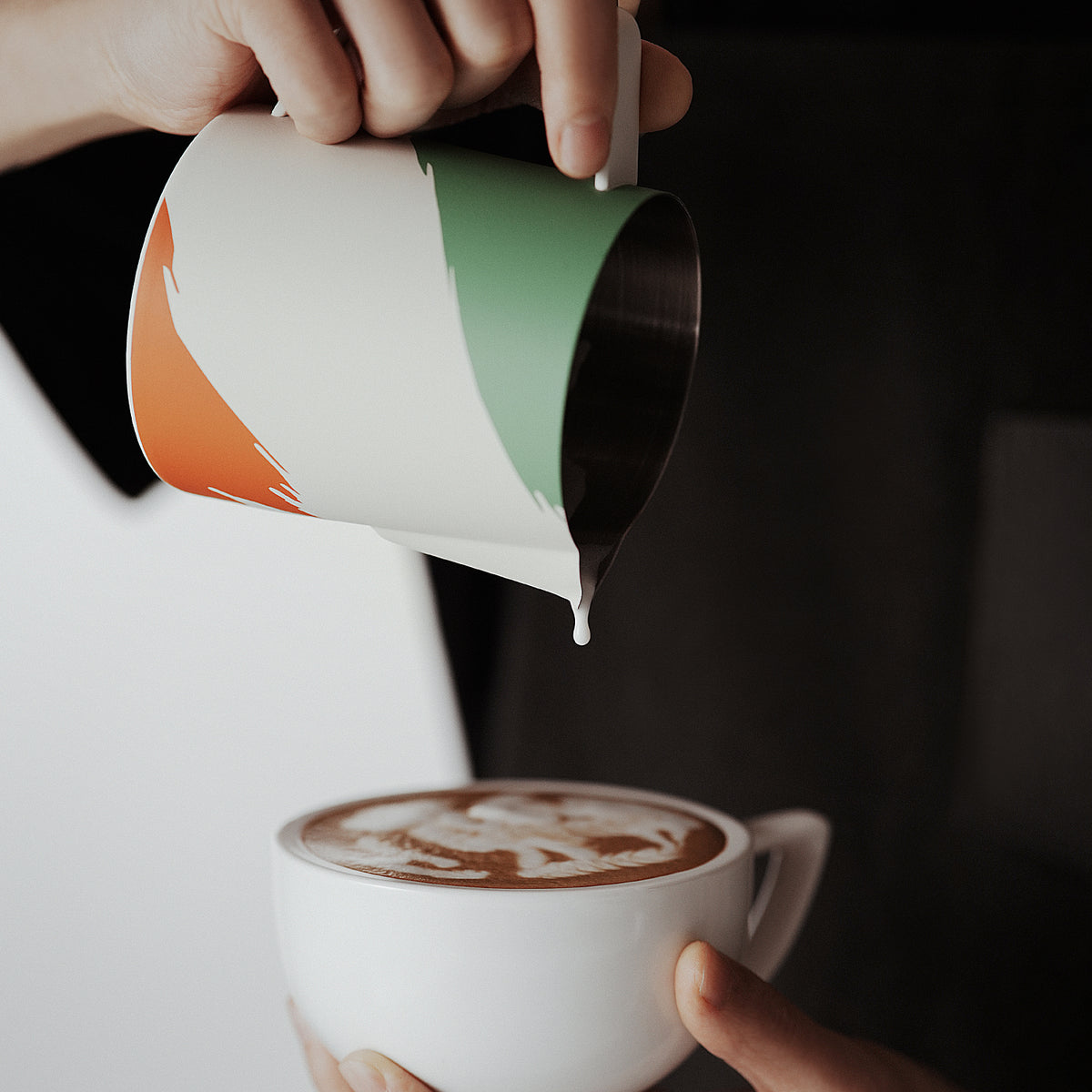 MHW-3BOMBER P6941 Milk Pitcher 5.0, 500 ml WBC Milan artwork — latte pour into a plain white cup. Tamper, cups and other scene items are not included.