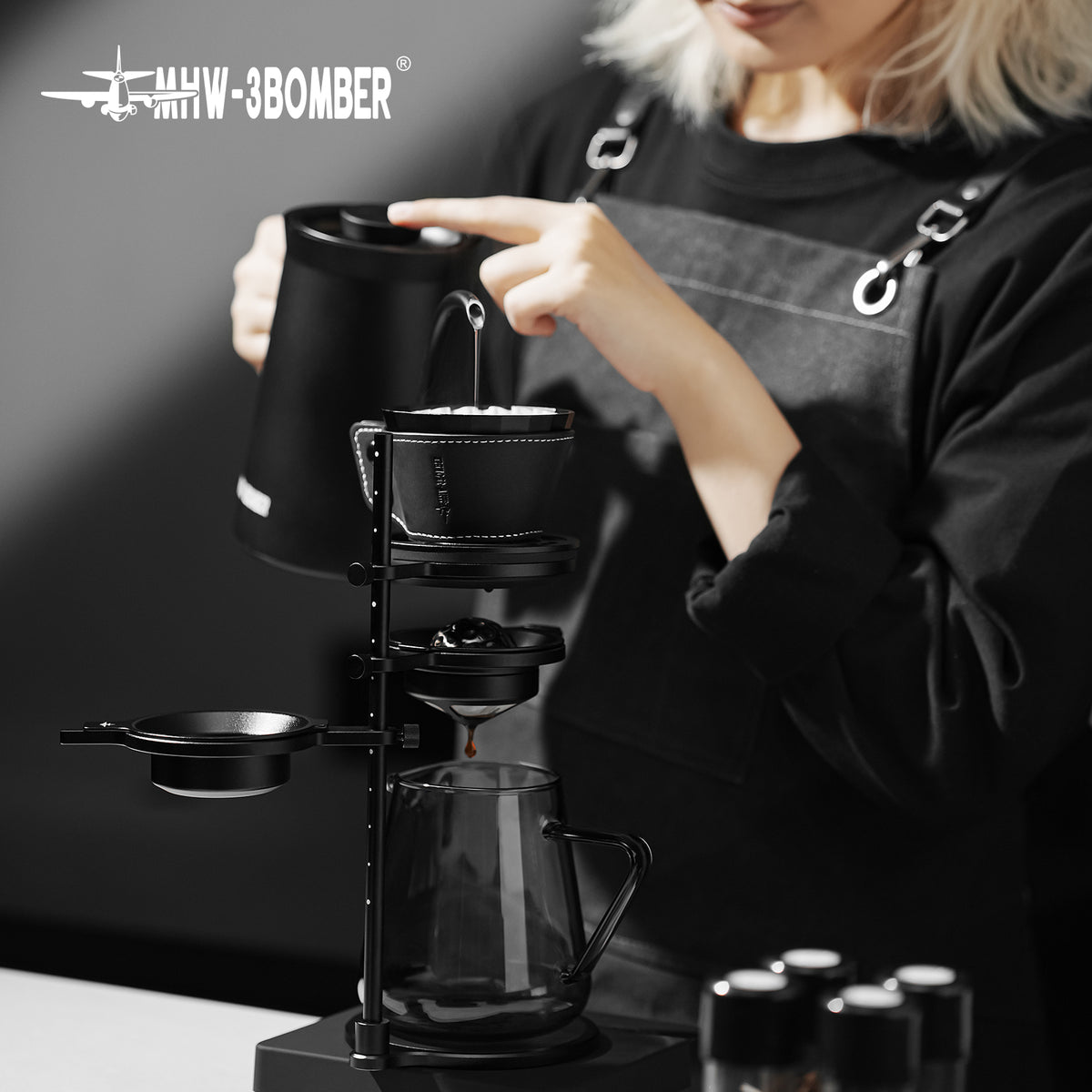 MHW-3BOMBER Meteorite Dripper FC6555B, Obsidian Black, pouring on a brewing stand; kettle and stand are props