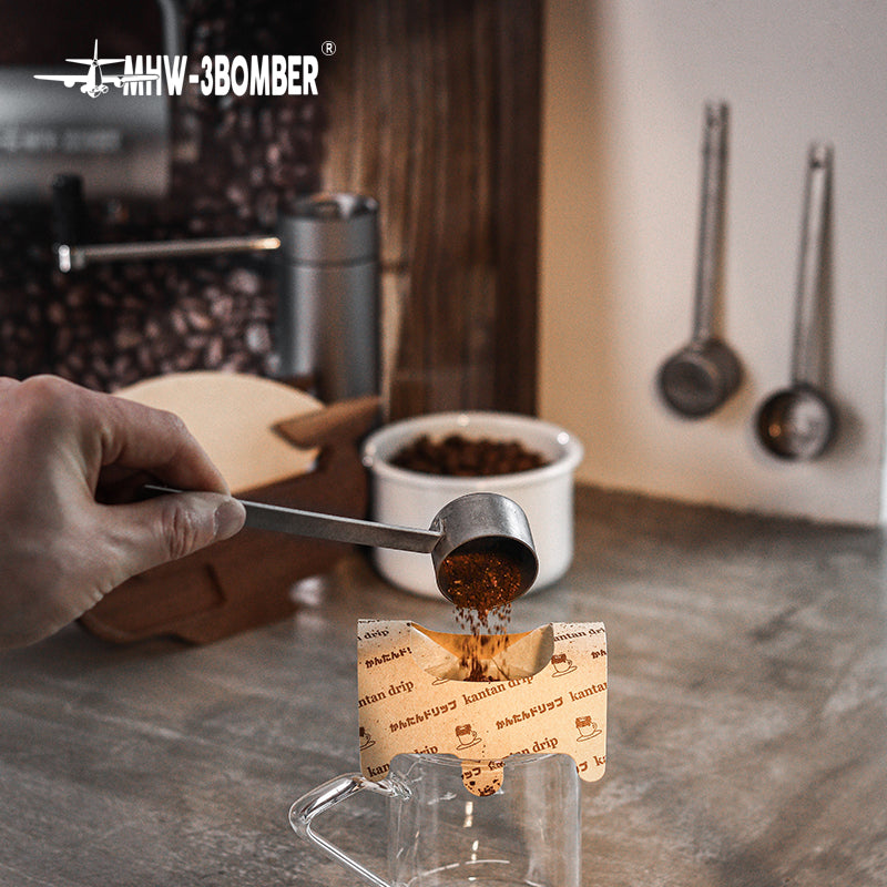 MHW-3BOMBER MS5438 silver-spot spoon measuring coffee beans beside a storage jar