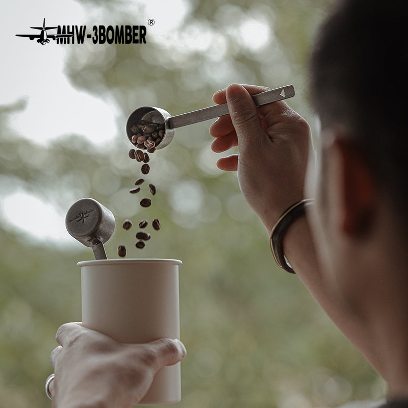 MHW-3BOMBER MS5438 silver-spot spoon pouring coffee into a cup