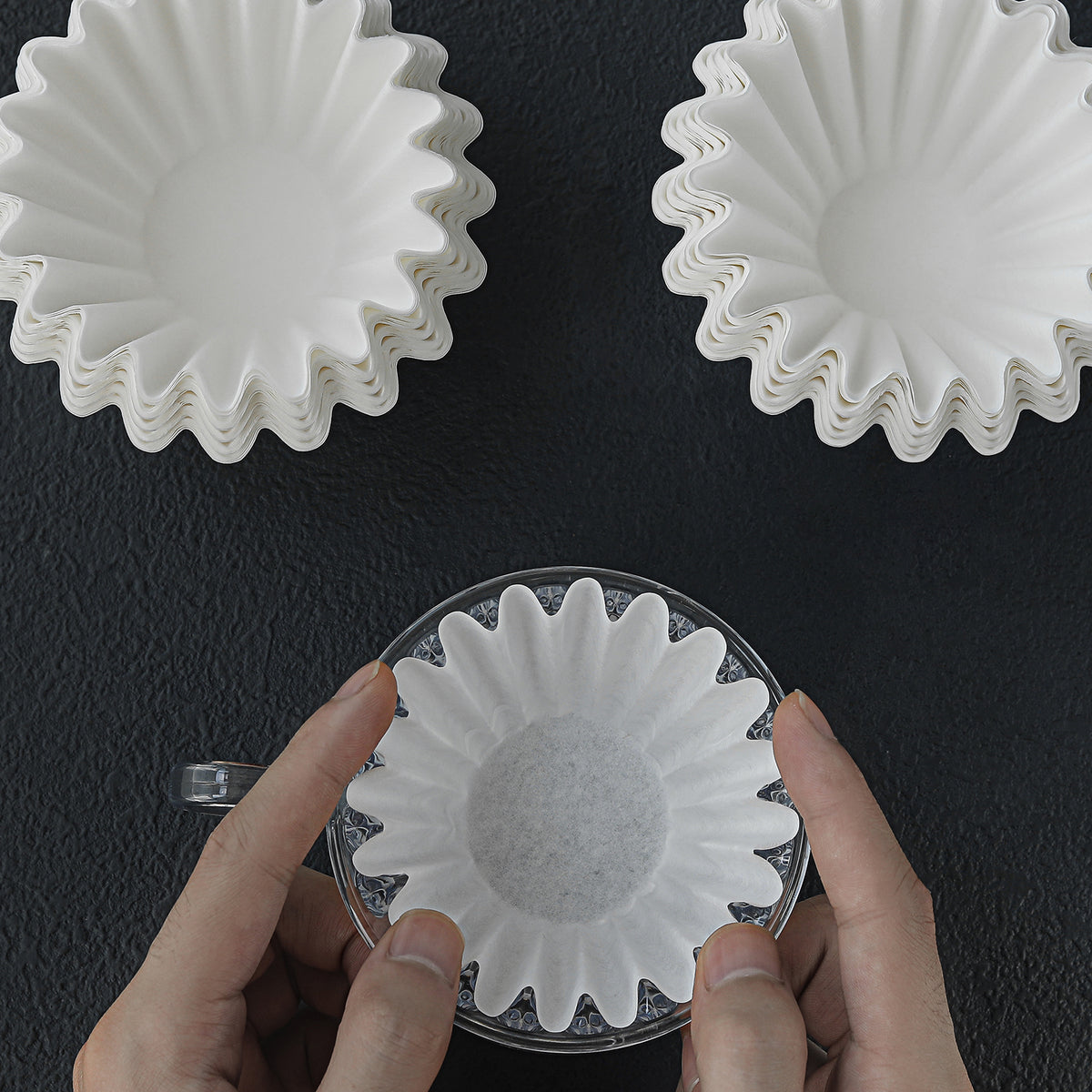 Cake-shaped paper filters shown during handling