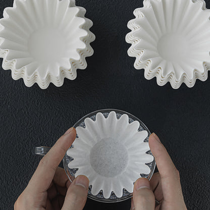 Cake-shaped paper filters shown during handling