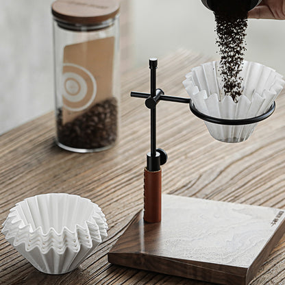 Cake-shaped filter paper beside a pour-over dripper