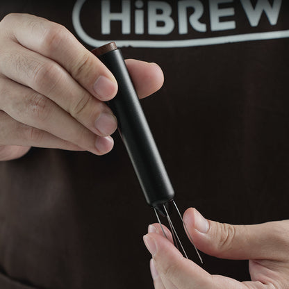 HiBREW Master Coffee WDT Tool — needle assembly and handle shown by hand. Demonstration props are not included.