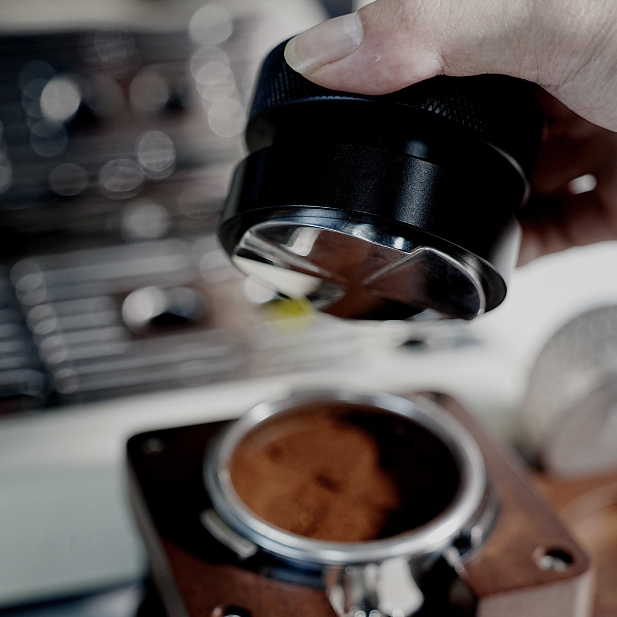 HiBREW Master 58mm Coffee Distributor — tool held above a portafilter. Demonstration props are not included.