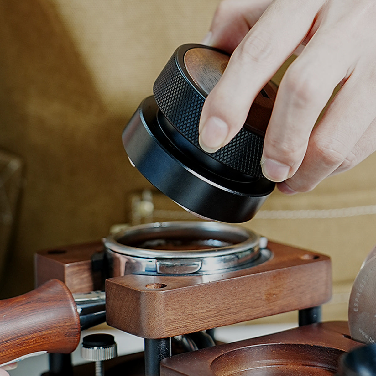 HiBREW Master 58mm Coffee Distributor — tool positioned above a tamping station. Demonstration props are not included.