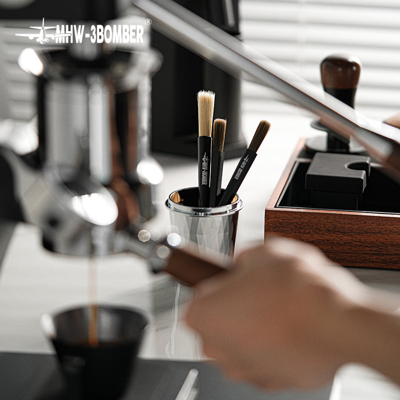 MHW-3BOMBER B5525B black ABS pen brush in a coffee bar setting