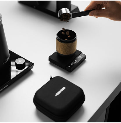 MHW-3BOMBER Cube Coffee Scale 3.0 Micro beside coffee equipment and its carrying case; shown items subject to supply confirmation (SKU ES5788B).