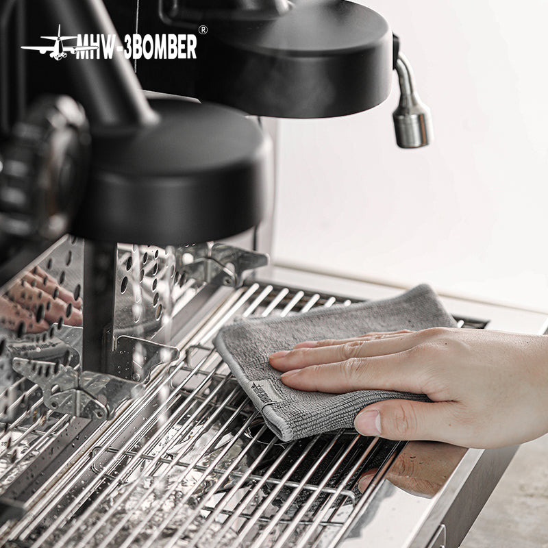 Grey towel from the MHW-3BOMBER CT5322 four-piece blue and grey set wiping a drip tray; espresso machine is not included