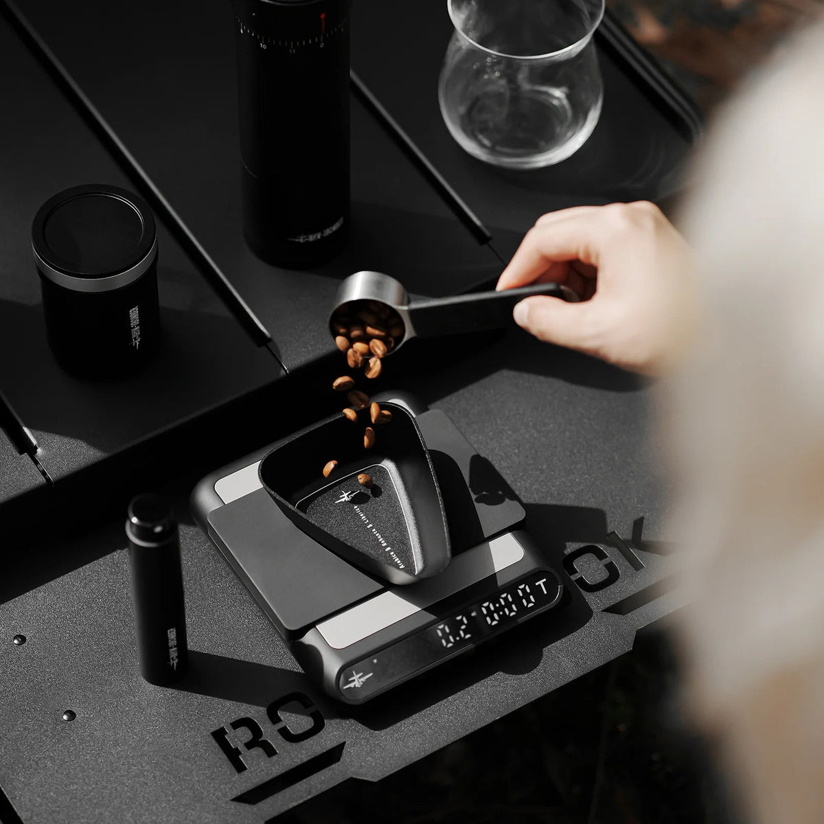 MHW-3BOMBER SB6559 black RDT bottle beside a bean dosing tray; other equipment and beans are demonstration props, not included