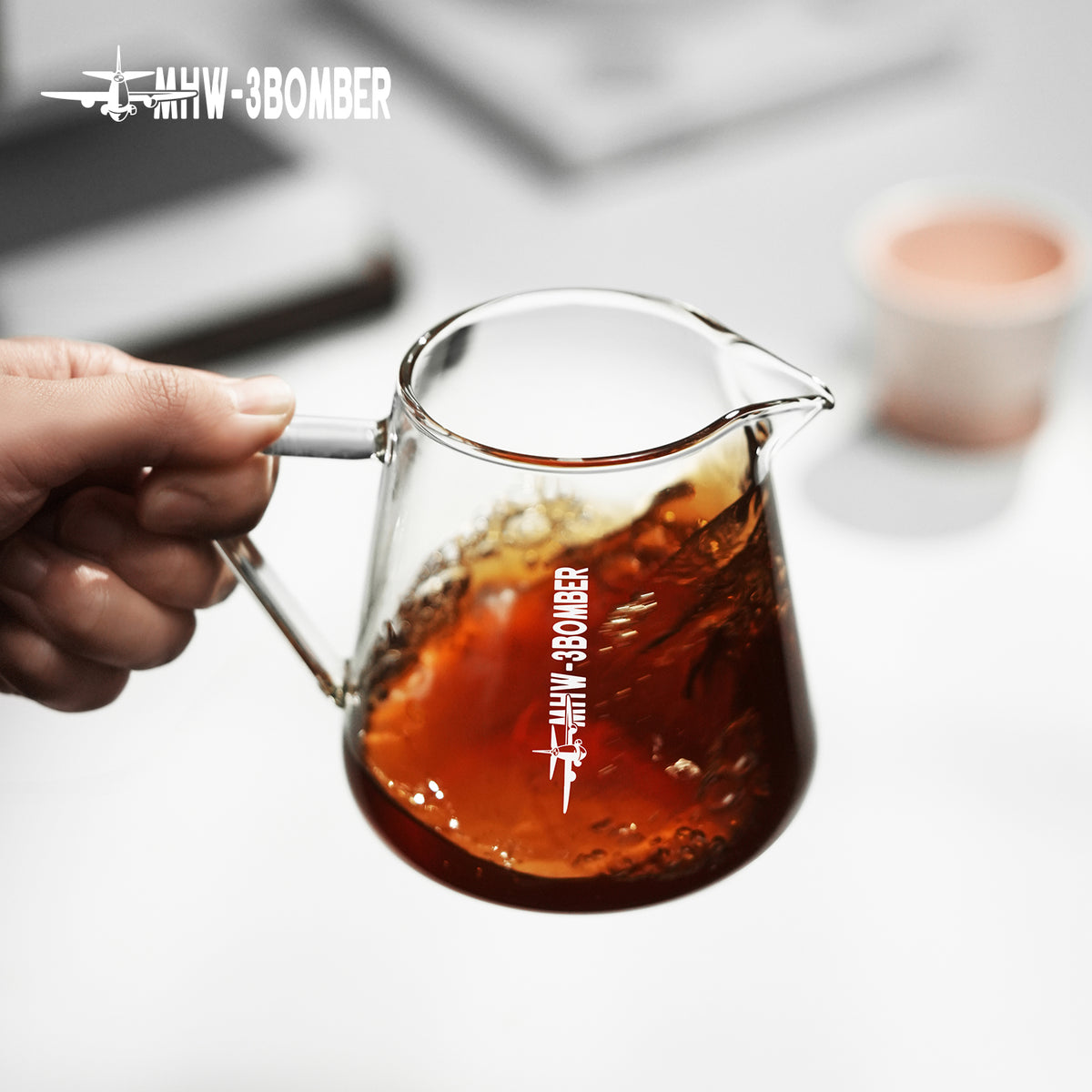 G5096 Clear server held by its glass handle with an iced drink. Other pictured tools, coffee and props are not included.