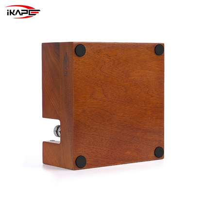 Underside of the IKAPE walnut tamping station, showing four non-slip feet.