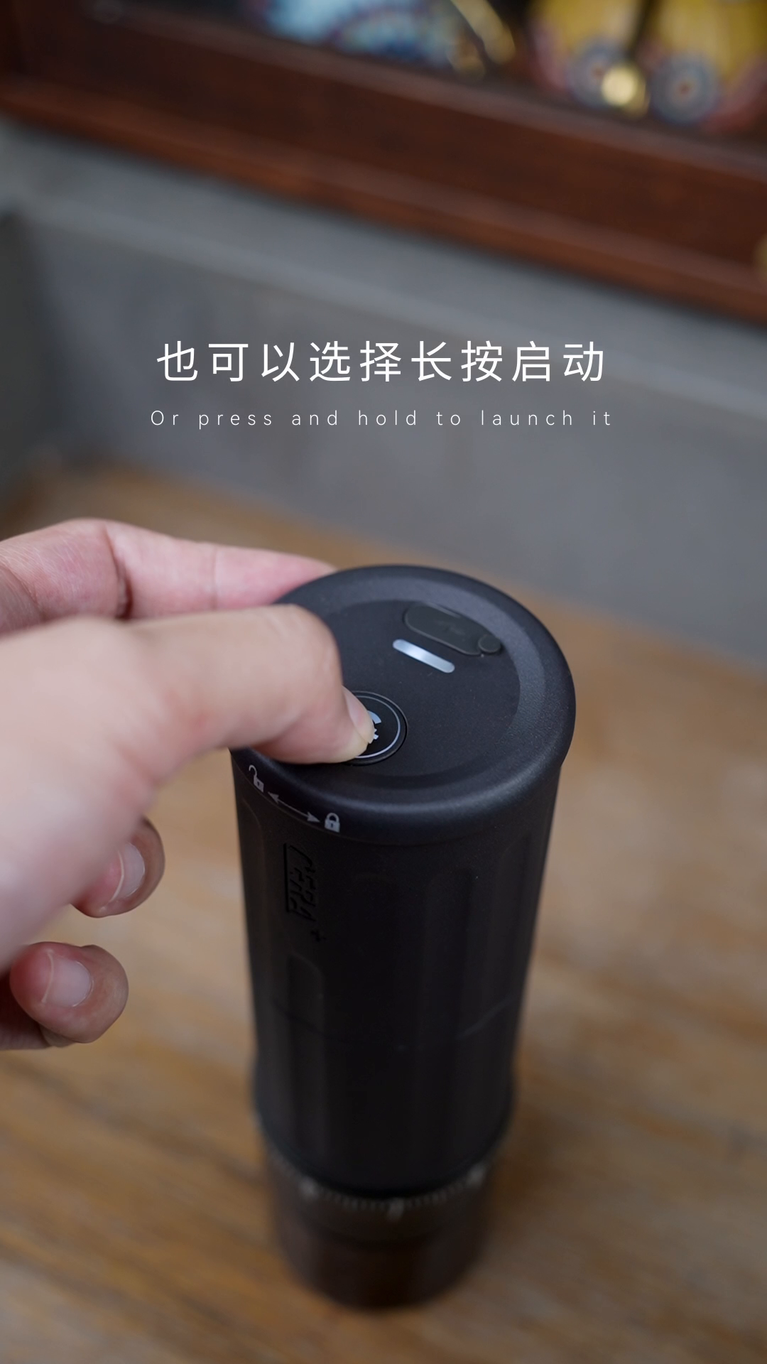 Pressing the operating button on the CERA+ CGE03 Space Grey electric grinder