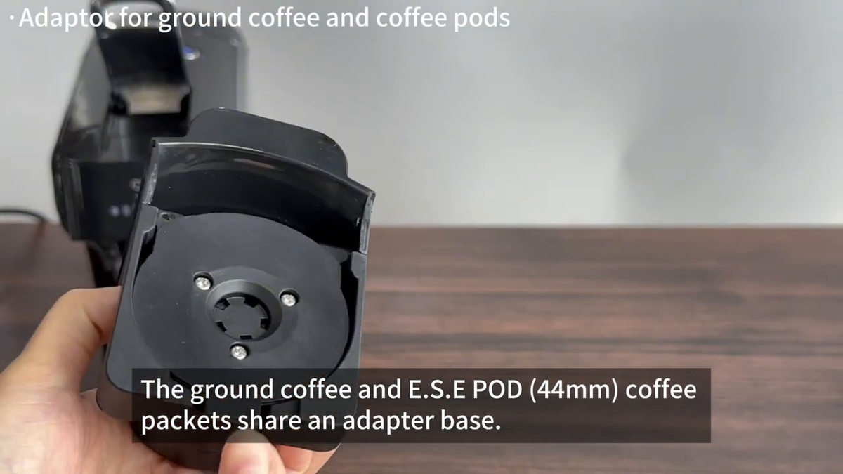 HiBREW H1B Black — ground-coffee and ESE adapter in front of black machine