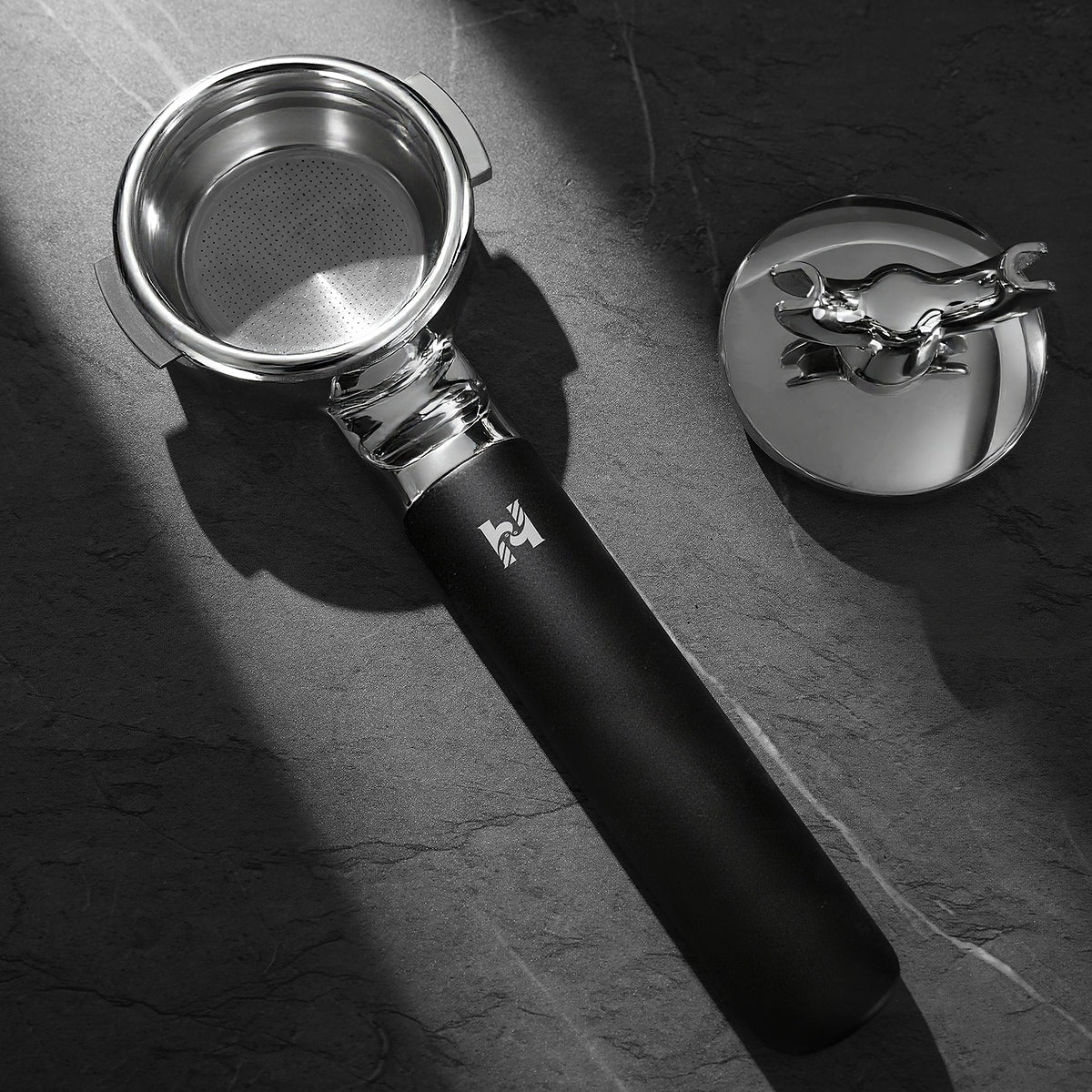 HiBREW H21 Magician 58mm Portafilter — basket view with detachable spout assembly beside the handle. Scene props are not included unless quoted.