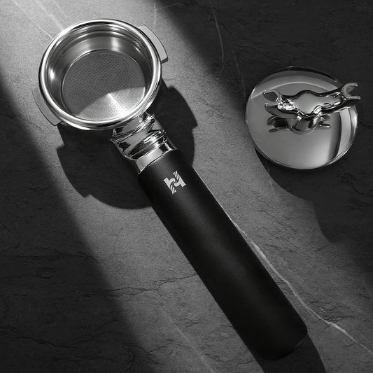 HiBREW H21 Magician 58mm Portafilter — basket view with detachable spout assembly beside the handle. Scene props are not included unless quoted.