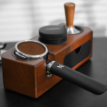 HiBREW H21 Magician 58mm Portafilter — filled basket resting in a tamping station. Scene props are not included unless quoted.