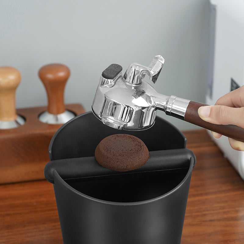 HiBREW Coffee Knock Box — portafilter handling demonstration above the knock bar. Demonstration props are not included.