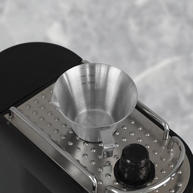 HiBREW 100ml Espresso Measuring Pitcher — cup positioned on a drip tray. Demonstration props are not included.