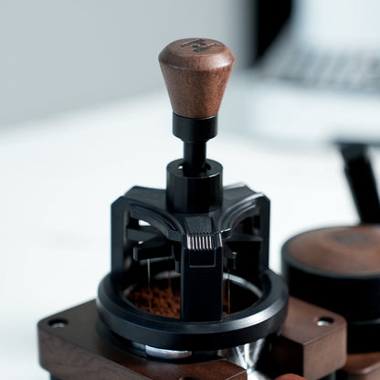 HiBREW Rotary 58mm WDT Tool — tool positioned on a coffee basket at a tamping station. Demonstration props are not included.