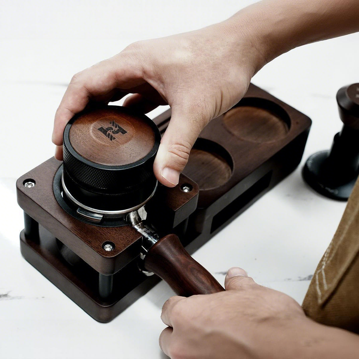 HiBREW Wood Tamping Station — distribution-tool demonstration above a portafilter. Demonstration props are not included.
