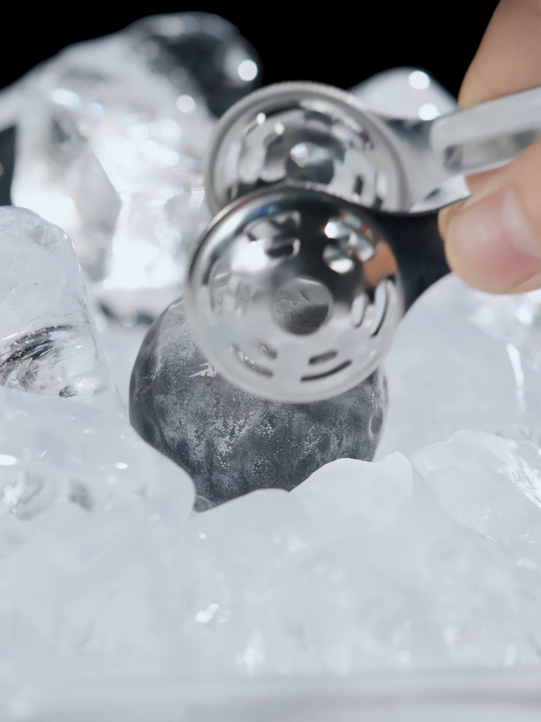 MHW-3BOMBER IH6658L 42 mm chilling ball lifted from ice; tongs and ice are demonstration props