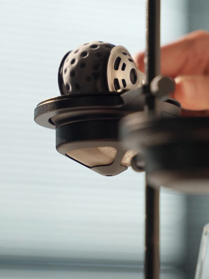 MHW-3BOMBER IH6658L 42 mm chilling ball placed into a pour-over holder; holder and dripper are sold separately