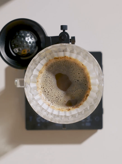 MHW-3BOMBER IH6658L 42 mm chilling ball beside a pour-over dripper in a top view; dripper and holder are separate
