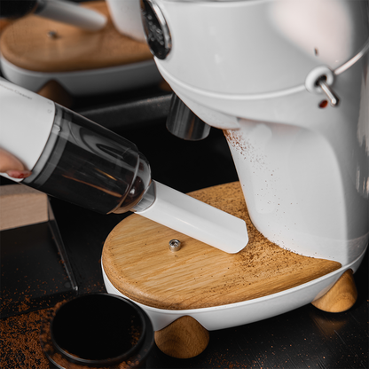 IKAPE White handheld vacuum cleaning around a coffee grinder