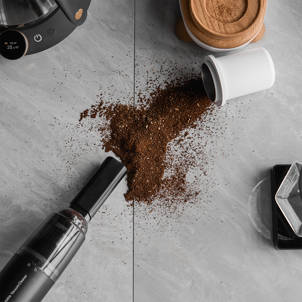 IKAPE Black vacuum cleaning spilled coffee grounds