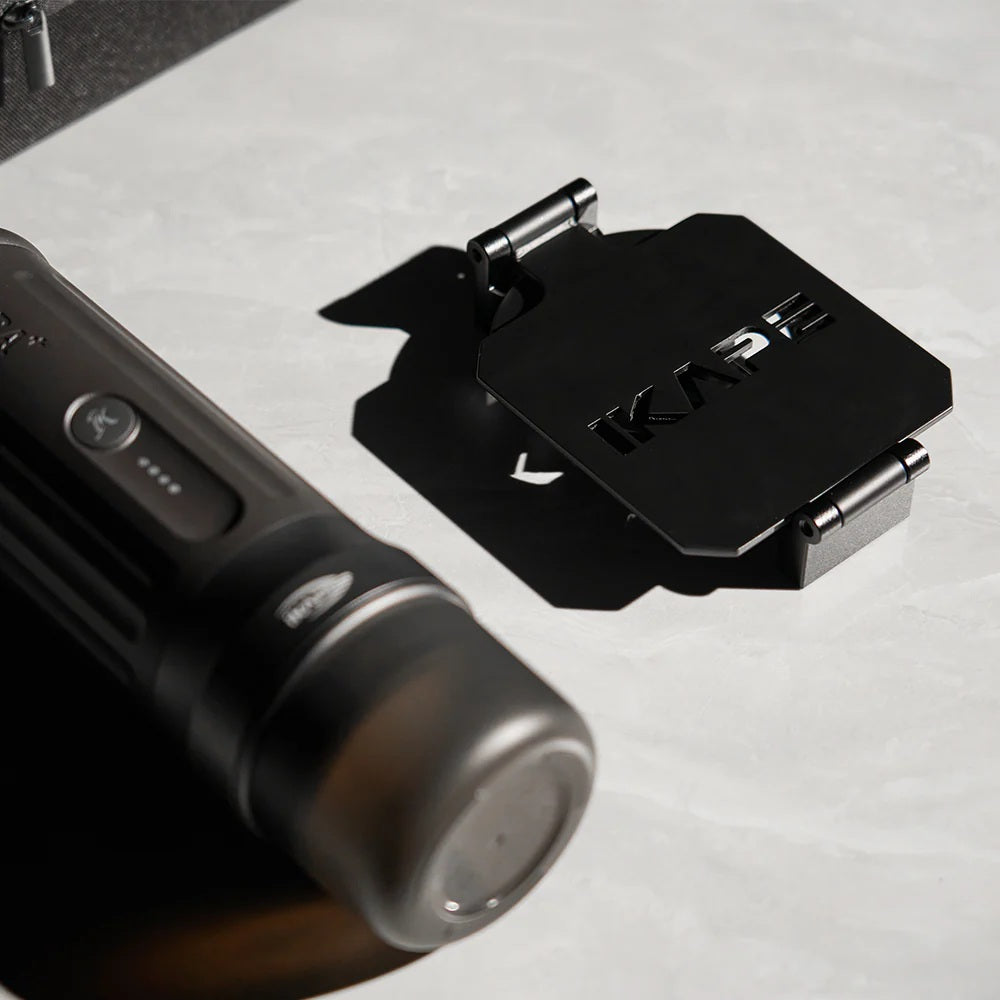 IKAPE black coffee maker stand folded flat on a counter