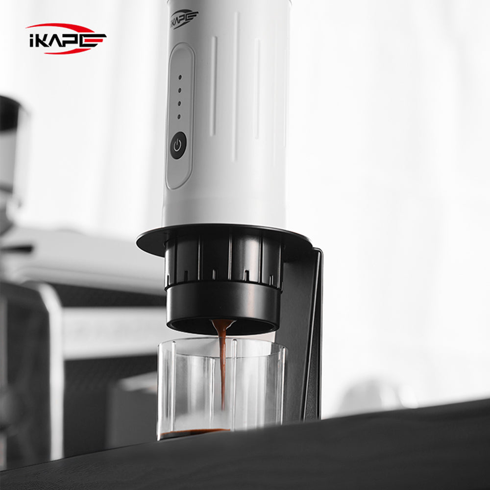IKAPE black standard portable coffee maker stand in use; coffee maker and cup are presentation props, photograph 10