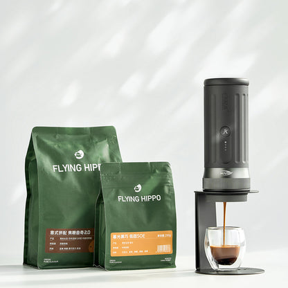 IKAPE black standard portable coffee maker stand in use; coffee maker and cup are presentation props, photograph 2