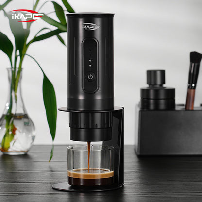 IKAPE black standard portable coffee maker stand in use; coffee maker and cup are presentation props, photograph 7