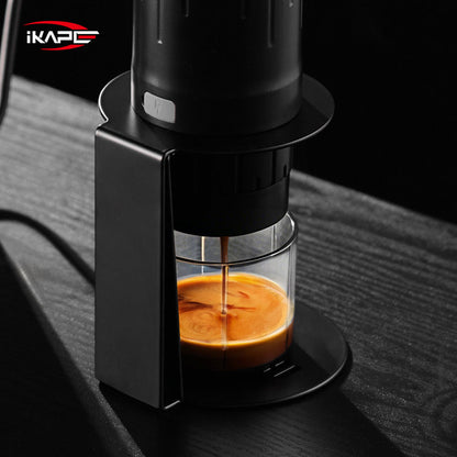 IKAPE black standard portable coffee maker stand in use; coffee maker and cup are presentation props, photograph 9