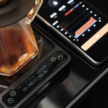 IKAPE V2 Pro black scale used with a coffee server and phone