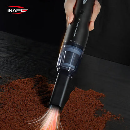 IKAPE Black handheld vacuum with a brush attachment cleaning coffee grounds