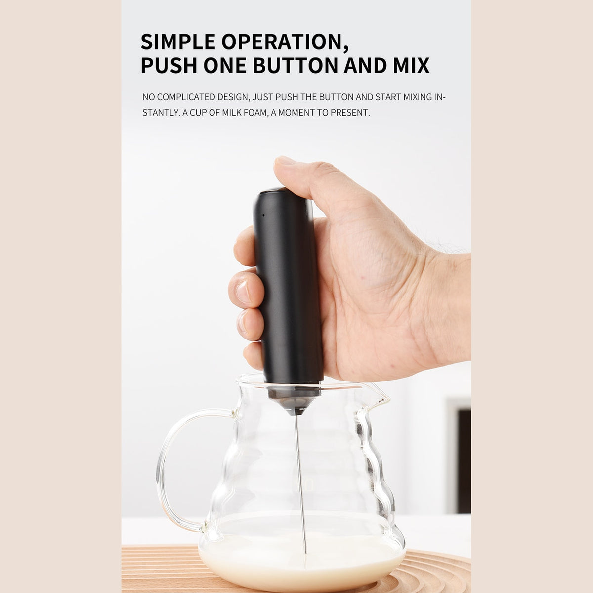 CLITON KJBQ-65 handheld milk frother in use in a milk pitcher
