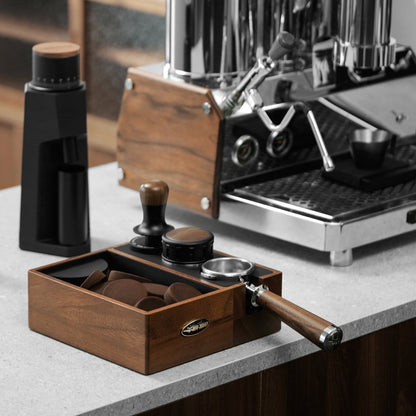 MHW-3BOMBER Walnut CH6624 multifunction knock box beside an espresso machine; tools and machine are props