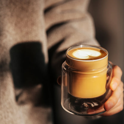 MHW-3BOMBER Clear H-shaped 160 ml DW glass cup held with milk coffee; beverage is illustrative