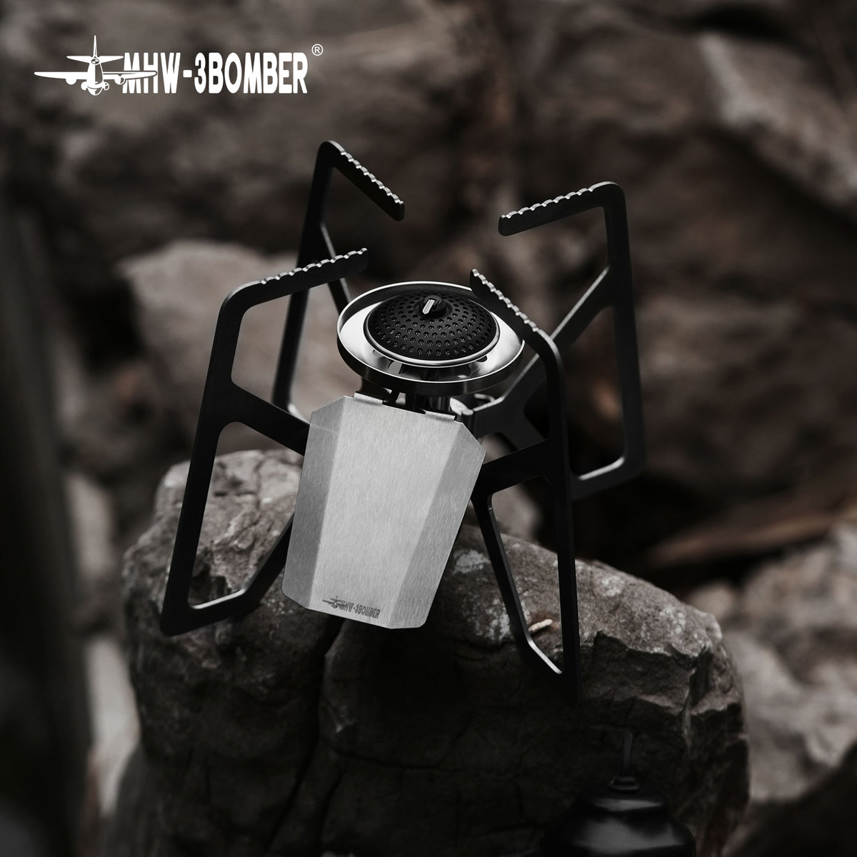 MHW-3BOMBER MET stove shown on a rock surface, separate supplier angle