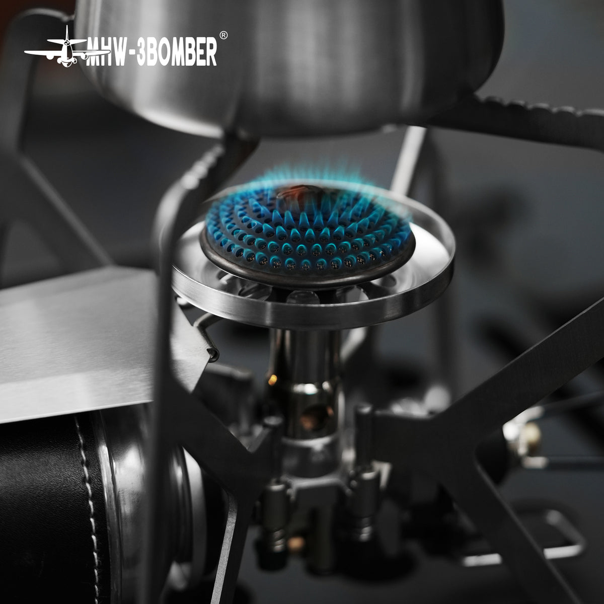MHW-3BOMBER MET stove burner close view during an outdoor cookware demonstration; cookware and fuel not included