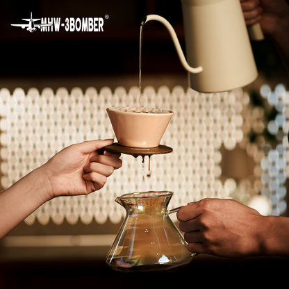 MHW-3BOMBER Lotus Pink dripper held above a server during pouring; kettle and server not included