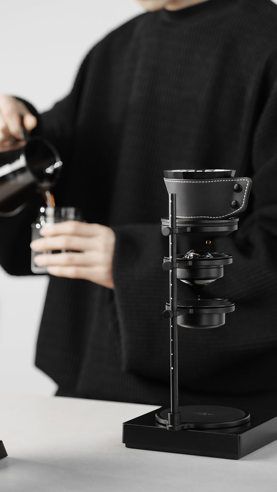 MHW-3BOMBER Obsidian Black stand with dripper during manual pouring, front view