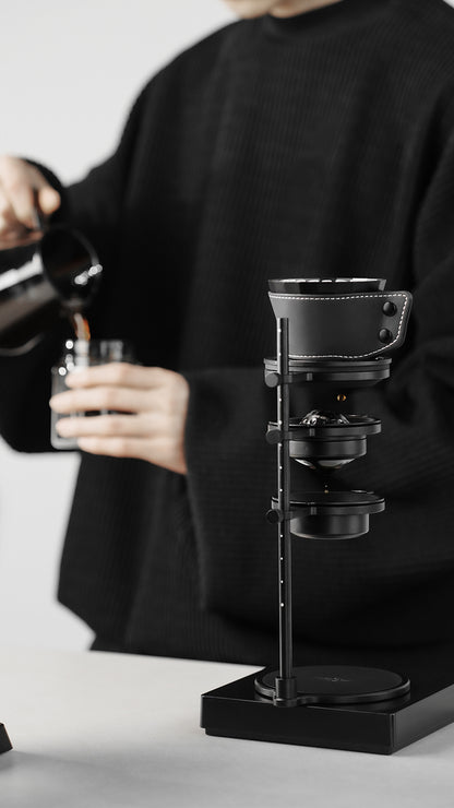MHW-3BOMBER Obsidian Black stand with dripper during manual pouring, front view