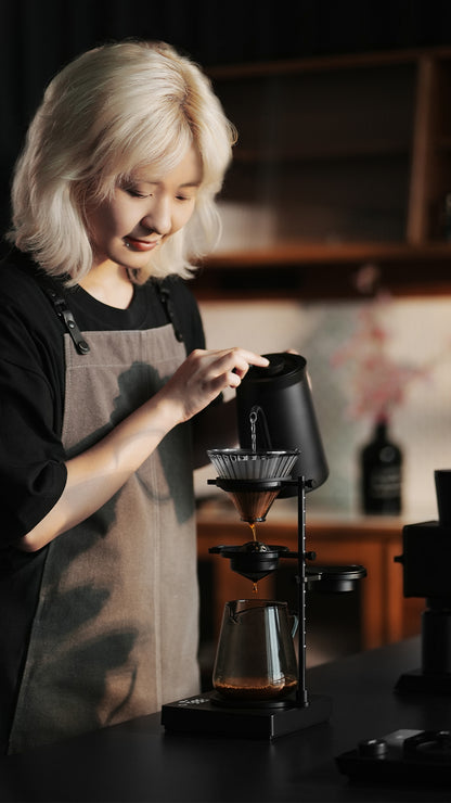 MHW-3BOMBER Obsidian Black stand in a side-view brewing demonstration