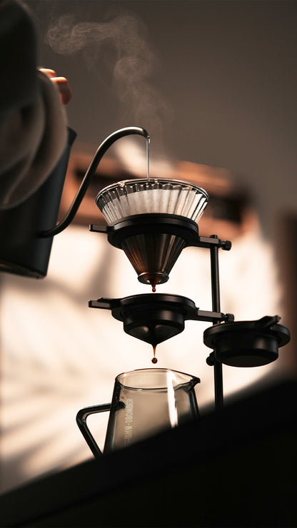 MHW-3BOMBER Obsidian Black stand with a dripper in a close brewing setup