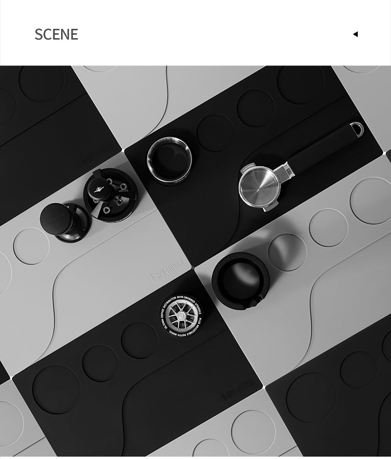 MHW-3BOMBER Black and Grey recessed Yu mats in an overhead workstation layout; coffee tools are reference props