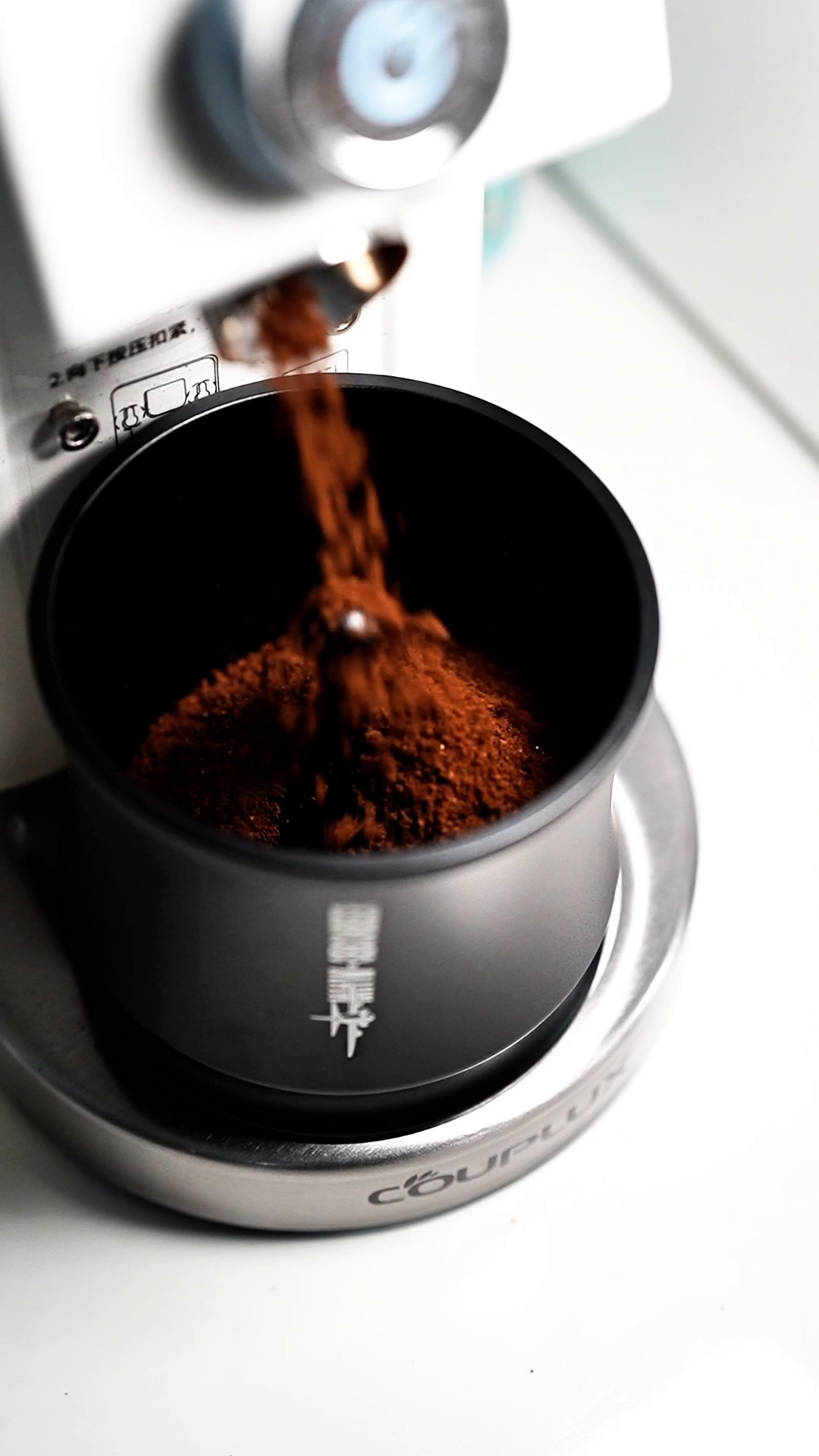 MHW-3BOMBER DR7031B Titanium Black FlowLight cup receiving ground coffee from a grinder; grinder not included